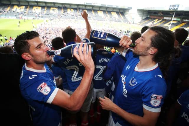 Gareth Evans and Christian Burgess celebrate Pompey's promotion. Picture: Joe Pepler