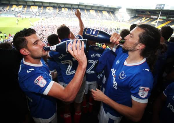Gareth Evans and Christian Burgess celebrate Pompey's promotion. Picture: Joe Pepler