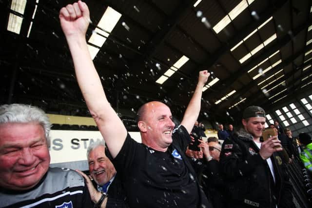 Paul Cook celebrates Pompey's promotion. Picture: Joe Pepler
