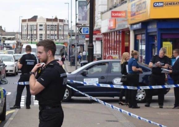 Police outside Barclays Bank in London Road, North End, on Julu 9, 2016, after a woman was stabbed. Picture: Loughlan Campbell PPP-170418-093131001