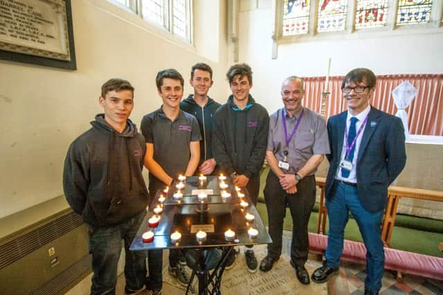 Students and tutors from CEMAST in St Peters Church, Titchfield, with the candlestand they made