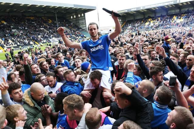 Christian Burgess is carried off the pitch at Meadow Lane by Pompey fans Picture: Joe Pepler