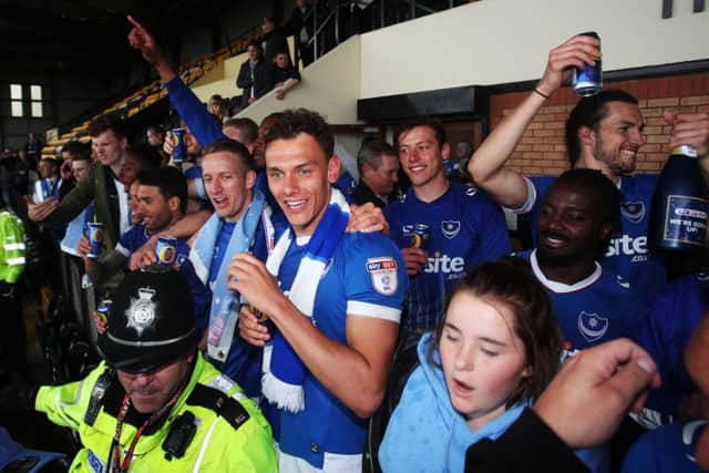 The Pompey players celebrate promotion at Notts County on Monday Picture: Joe Pepler