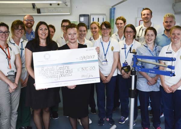 Staff from John Lewis in Southsea hand over a cheque to the physiotherapists at Queen Alexandra Hospital, in Cosham