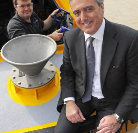 (Left to right)  Peter Verdon, Un-Manned Systems Developer, with Mark Garnier MP, Parliamentary Under Secretary of State on one of the craft built by ASV Global. Picture:  Malcolm Wells