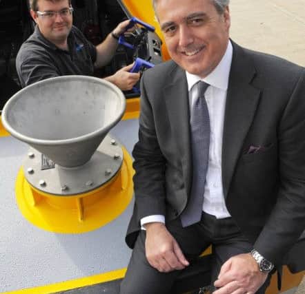 (Left to right)  Peter Verdon, Un-Manned Systems Developer, with Mark Garnier MP, Parliamentary Under Secretary of State on one of the craft built by ASV Global. 

Picture:  Malcolm Wells