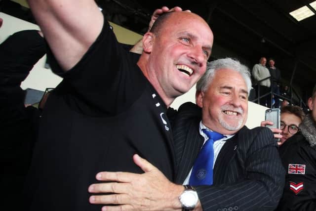 Pompey boss Paul Cook, left, celebrates promotion with Blues chairmain Iain McInnes at Notts Countys Meadow Lane last Monday Picture: Joe Pepler