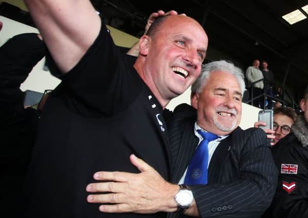 Pompey boss Paul Cook, left, celebrates promotion with Blues chairmain Iain McInnes at Notts Countys Meadow Lane last Monday Picture: Joe Pepler