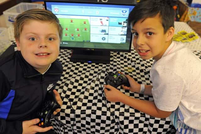 Ronnie Marks, eight, left, from Cosham enjoys a game with Lennon Wearn, nine, from Wymering
Picture: Malcolm Wells (170420-1120)