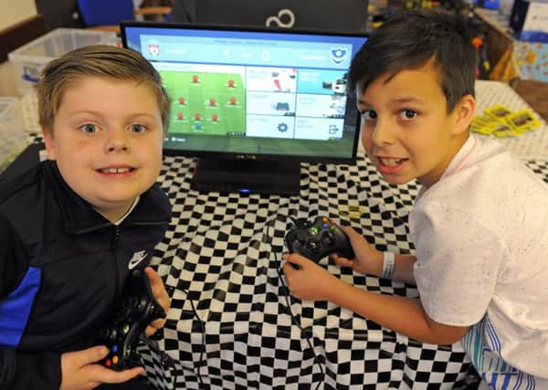 Ronnie Marks, eight, left, from Cosham enjoys a game with Lennon Wearn, nine, from Wymering
Picture: Malcolm Wells (170420-1120)