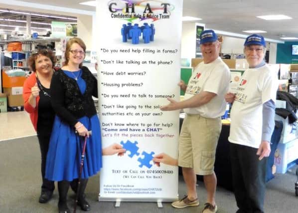 Gosportarians Malcolm Dent and Simon Mason, right, with Maria Fuccio and Jeanette Mae Perry from the advice organisation, CHAT, with the sign donated by Gosportarians