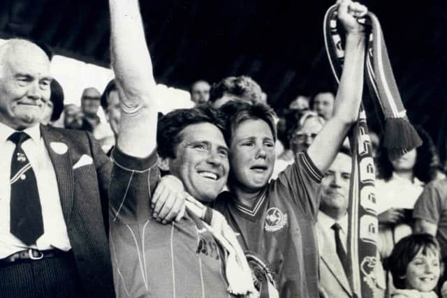 Alan Ball with son Jimmy after Pompey won promotion to the First Division at the end of the 1986-87 season