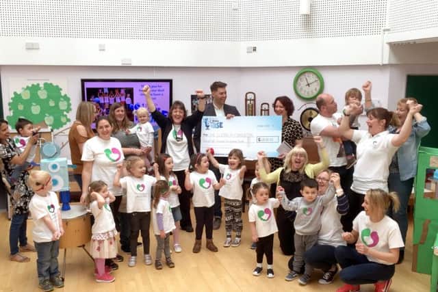 Delight as presenters from Heart Hampshire present the Elizabeth Foundation with a cheque