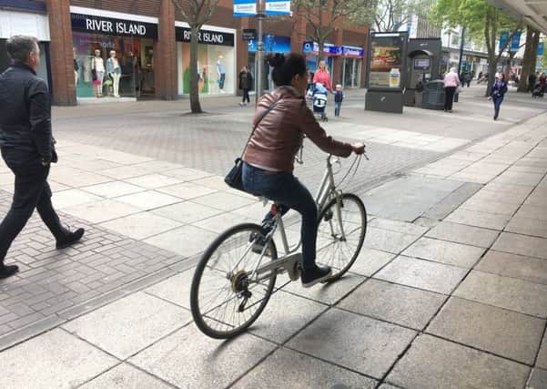 A woman on a bike in Commercial Road