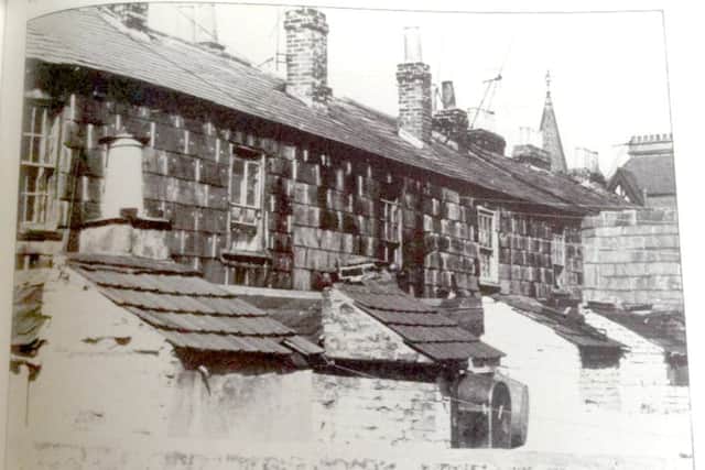 Tin baths hanging in the back yards of Henrietta Street, Landport