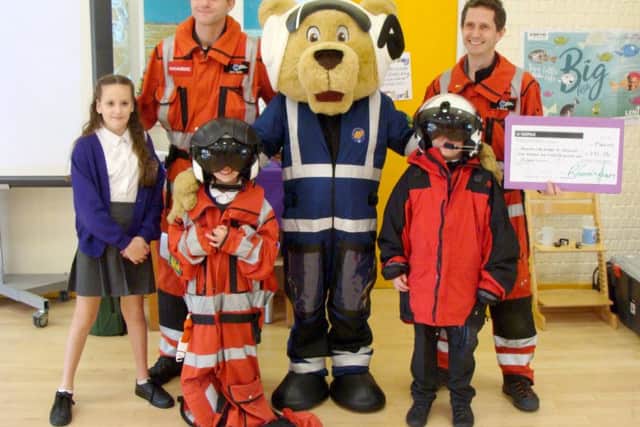 Doctors from Hampshire and Isle of Wight Air Ambulance and mascot Pilot Paws with pupils