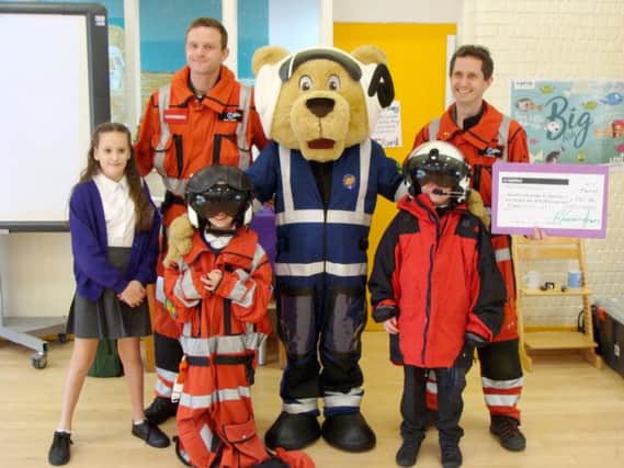Doctors from Hampshire and Isle of Wight Air Ambulance and mascot Pilot Paws with pupils