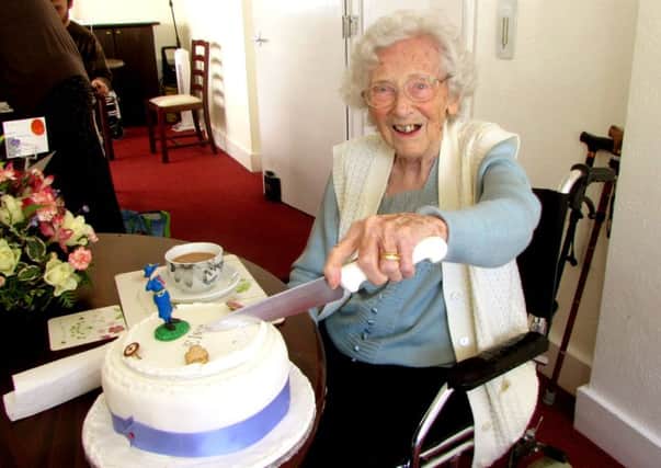 Elsie Pickles cutting her 104th birthday cake