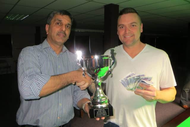 Mike Talmondt gets his trophy from Pat Patel. Picture: Tim Dunkley