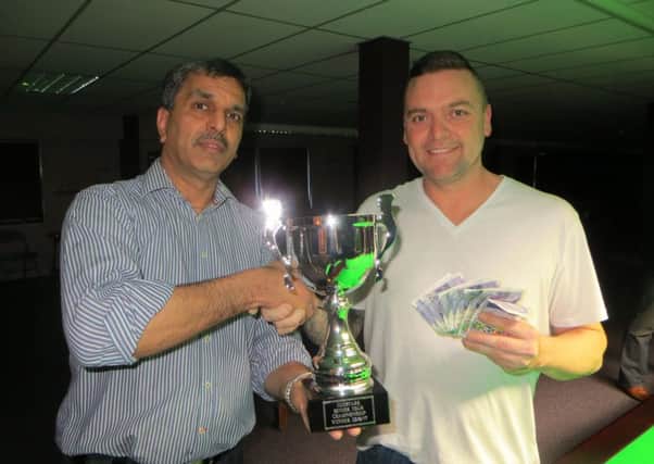 Mike Talmondt gets his trophy from Pat Patel. Picture: Tim Dunkley