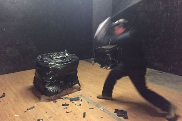 Grange Live Gaming's managing director Jim Sephton takes a baseball bat to a home telephone in the UK's first "Rage Room" attraction
Picture: Richard Vernalls/PA Wire