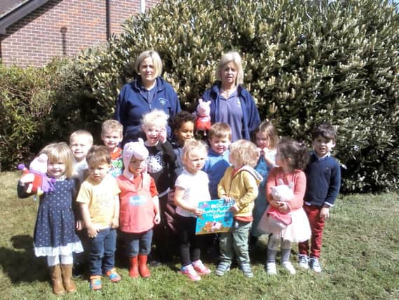 Supervisor Emily Moore, left, and deputy supervisor Becky Lansley, back right, with children from Hambledon Pre-School getting ready for their Muddy Puddle Walk for Save the Children