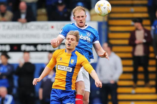 Matt Clarke wins an aerial battle with Mansfield's Danny Rose Picture: Joe Pepler