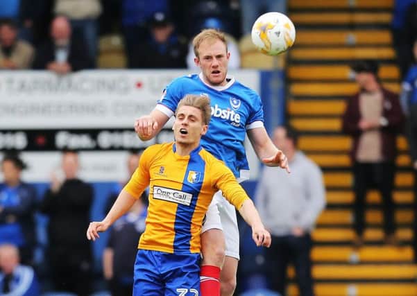 Matt Clarke wins an aerial battle with Mansfield's Danny Rose Picture: Joe Pepler