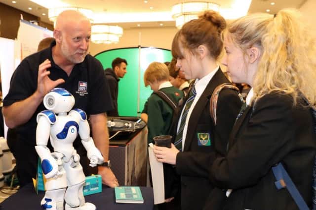 CURIOUS Jack the robot being shown off by WO Stu Clayton to Elizabeth Devane and Daisy Savage