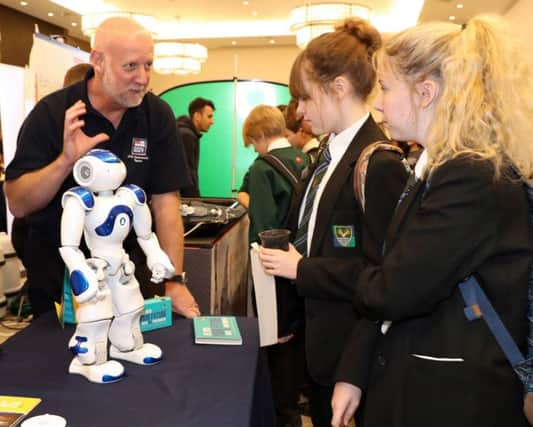 CURIOUS Jack the robot being shown off by WO Stu Clayton to Elizabeth Devane and Daisy Savage