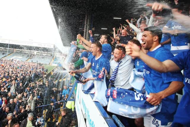 The Pompey players celebrate overlooking the fans who made it onto the pitch at Fratton Park Picture: Joe Pepler