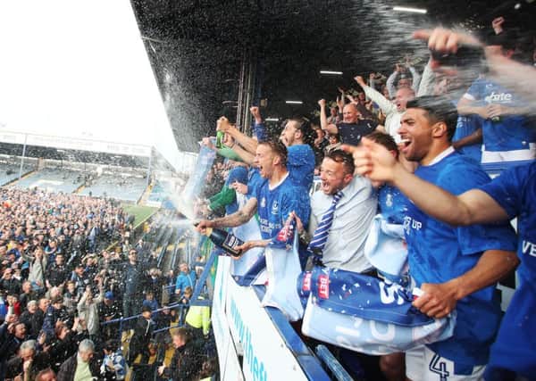 The Pompey players celebrate overlooking the fans who made it onto the pitch at Fratton Park Picture: Joe Pepler