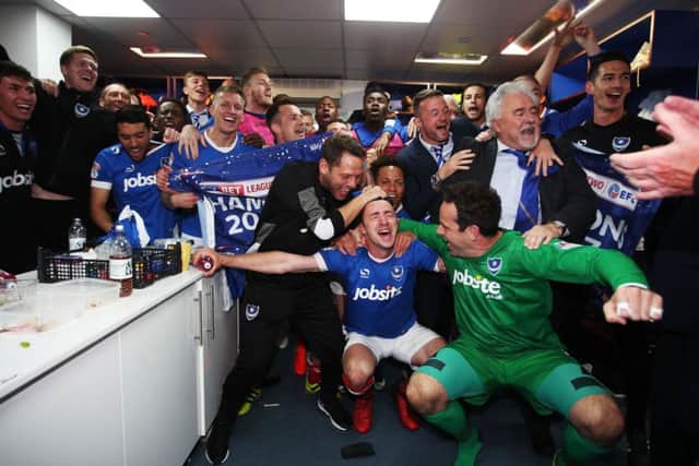 The Pompey players celebrate in the dressing room at Fratton Park