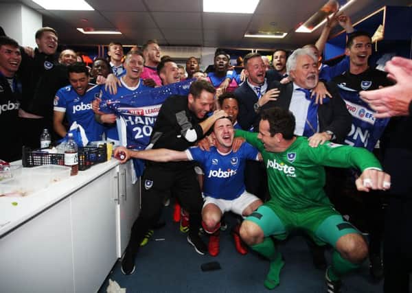 The Pompey players celebrate in the dressing room at Fratton Park