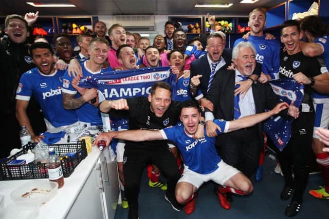 Pompey staff and players celebrate after Saturday's triumph. Picture: Joe Pepler