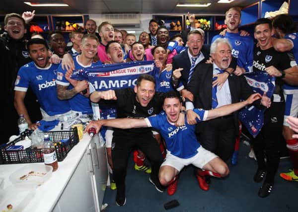 Pompey staff and players celebrate after Saturday's triumph. Picture: Joe Pepler