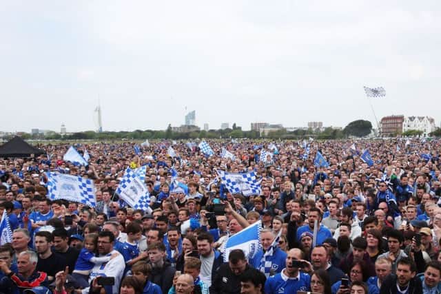 Pompey fans celebrating the club winning the League Two title on Southsea Common today. Picture: Joe Pepler.