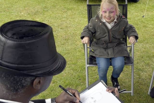 Grace Walton, six, from Leigh Park has her caricature sketched by artist Femi Adetunji at the Beat the Bullies fun day
Picture: Neil Marshall (170301-10)