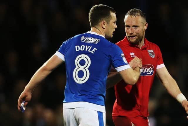 Ex-Pompey man Ben Davies shakes hands with Michael Doyle after the Blues win at Grimsby. Picture: Joe Pepler