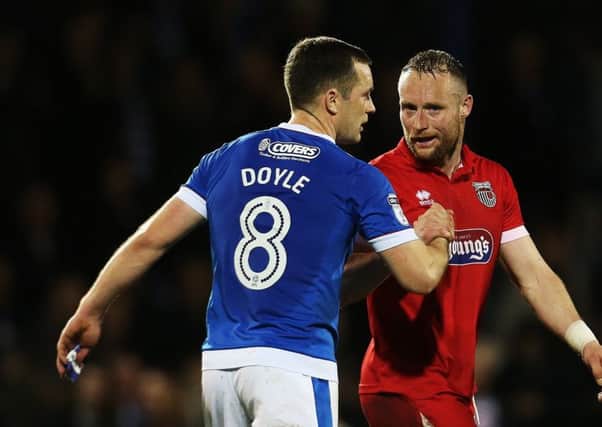 Ex-Pompey man Ben Davies shakes hands with Michael Doyle after the Blues win at Grimsby. Picture: Joe Pepler