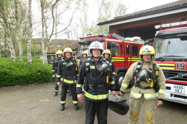 The firefighters with the kayak they will be carrying for charity