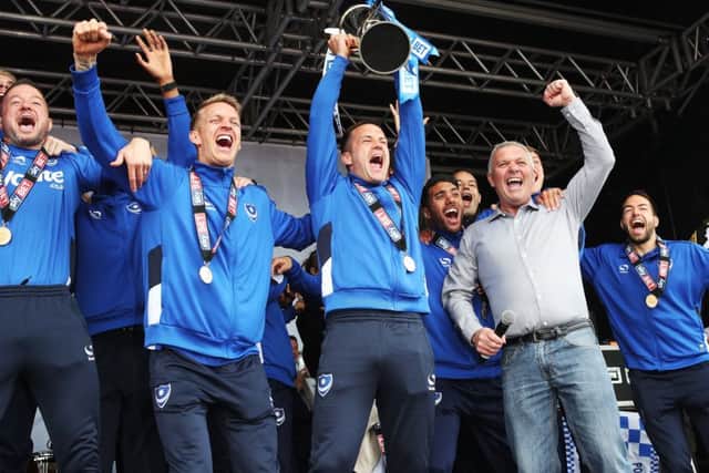 Michael Doyle lifts the League Two trophy. Picture: Joe Pepler