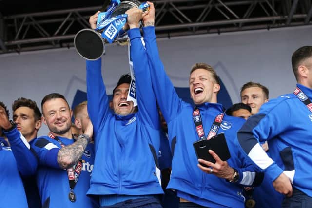 Gary Roberts and Carl Baker withthe League Two trophy