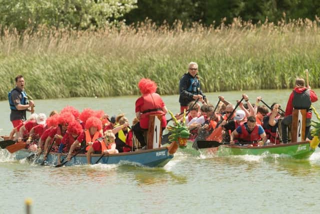 The Sassy Ladies in the red wigs race the Electric Slayers. Picture: Keith Woodland
