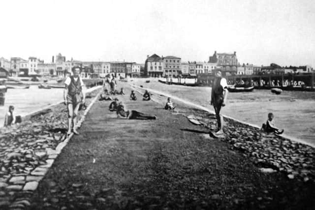 Mudlarks on the walkway out to the mudflats? 			                    Picture: Robert James collection
