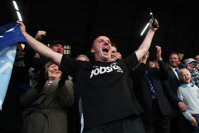 Paul Cook celebrates Pompey's League Two triumph Picture: Joe Pepler