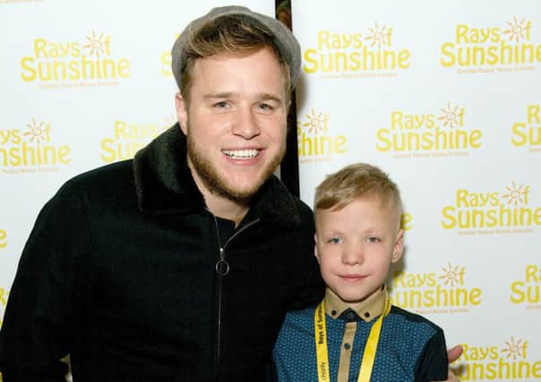 Olly Murs meeting eight-year-old Harry Holden at the Royal Albert Hall. Harry has complex illnesses. ENGPPP00120140702110517