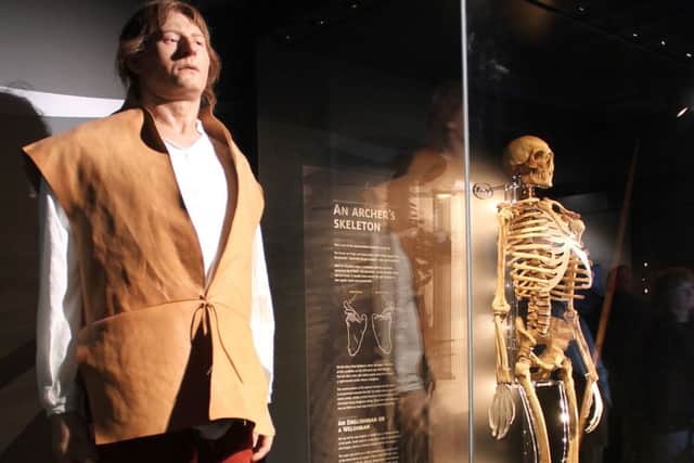 A reconstructed skeleton of the most complete individual skeleton from the Mary Rose to date, alongside a model of him as the archer