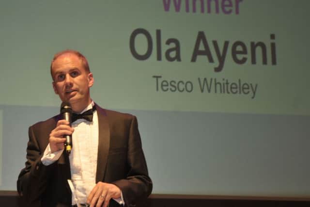 Neil Carter accepts the Customer Service Award on behalf of Ola Ayeni of Tesco Whiteley at last year's Retail & Leisure Awards