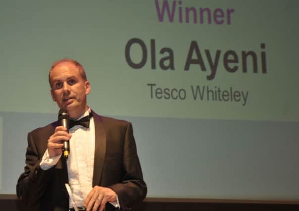 Neil Carter accepts the Customer Service Award on behalf of Ola Ayeni of Tesco Whiteley at last year's Retail & Leisure Awards